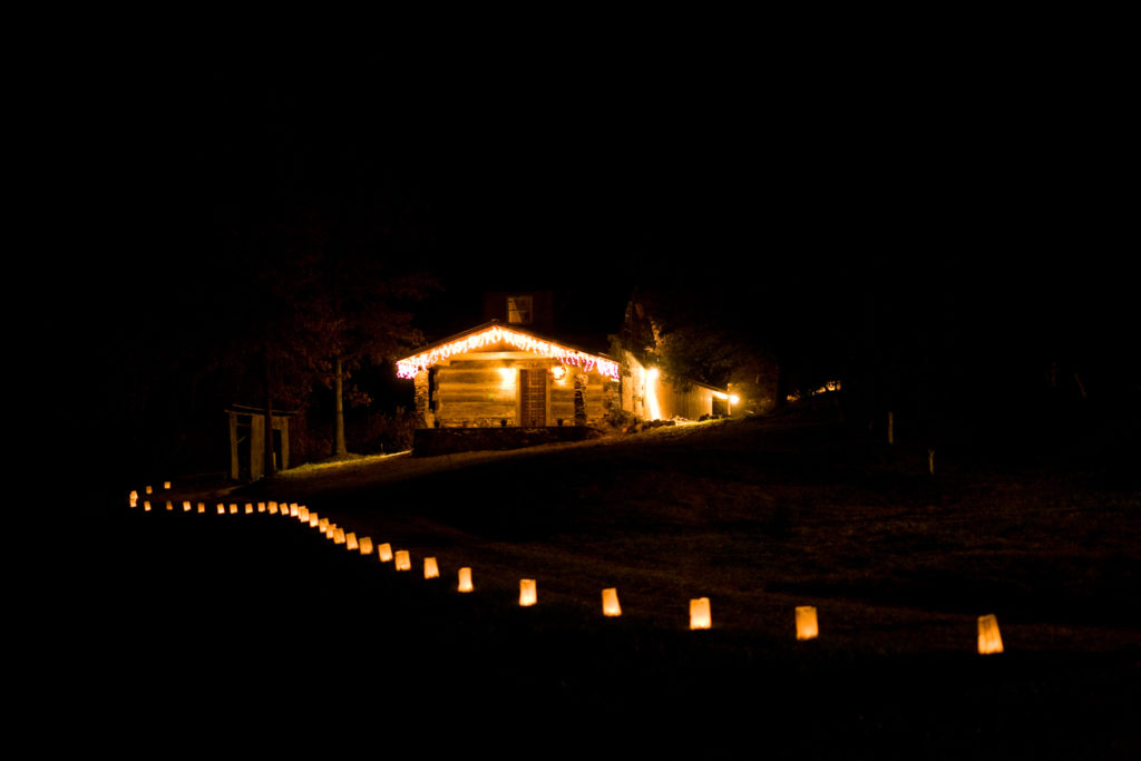 Cabin with Luminaries Lining the Driveway